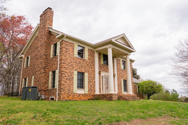 1601 Harvie Mills Rd W, Cookeville, TN 38501 - view of property exterior featuring a chimney, brick siding, and a lawn
