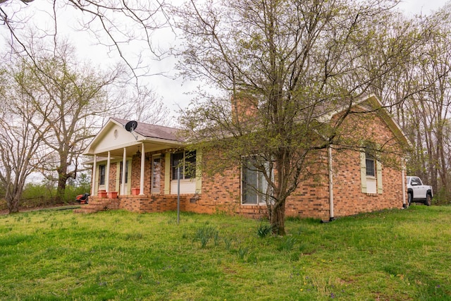 1601 Harvie Mills Rd W, Cookeville, TN 38501 - view of front of property with brick siding, a front yard, and a porch