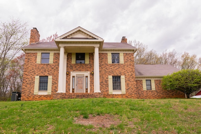 1601 Harvie Mills Rd W, Cookeville, TN 38501 - neoclassical / greek revival house with brick siding, a front lawn, and a chimney