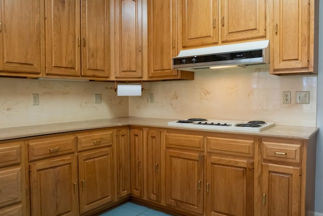 1601 Harvie Mills Rd W, Cookeville, TN 38501 - kitchen featuring tasteful backsplash, white electric stovetop, light countertops, under cabinet range hood, and tile patterned floors