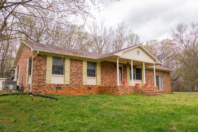 1601 Harvie Mills Rd W, Cookeville, TN 38501 - view of front facade featuring a front yard, brick siding, central AC, and covered porch