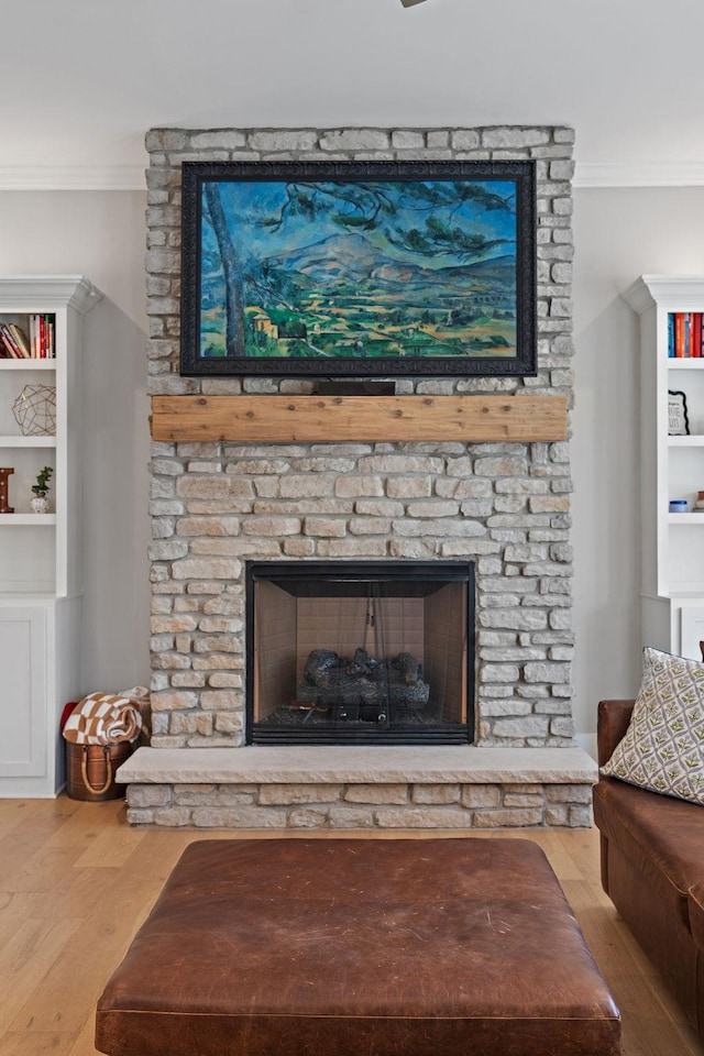 room details with crown molding, wood finished floors, and a fireplace