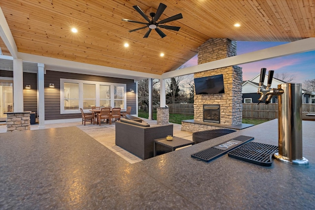 view of patio with outdoor dining space, ceiling fan, an outdoor living space with a fireplace, and fence