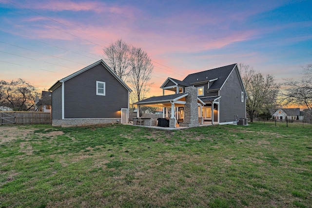 rear view of property with a yard, a patio, a fenced backyard, and central air condition unit