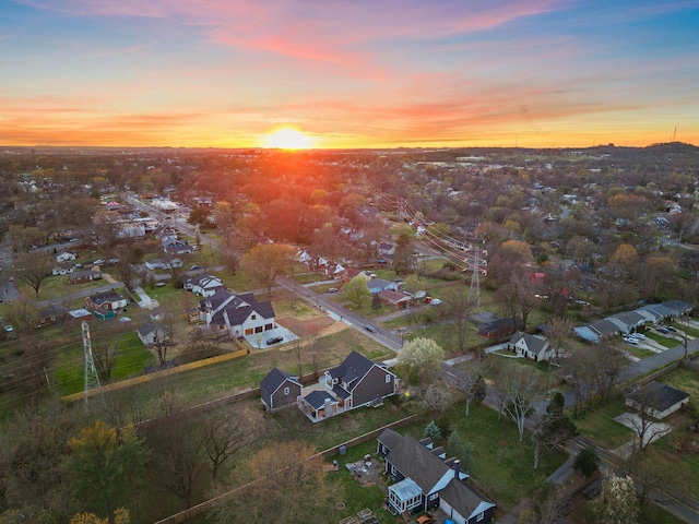 aerial view at dusk featuring a residential view