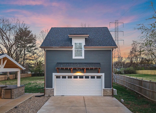 garage featuring a garage and fence