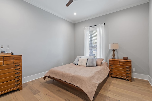 bedroom with crown molding, light wood finished floors, and baseboards