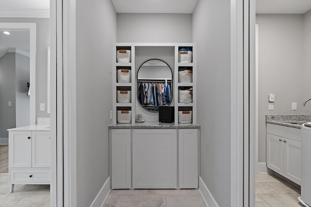 interior space with a sink and baseboards