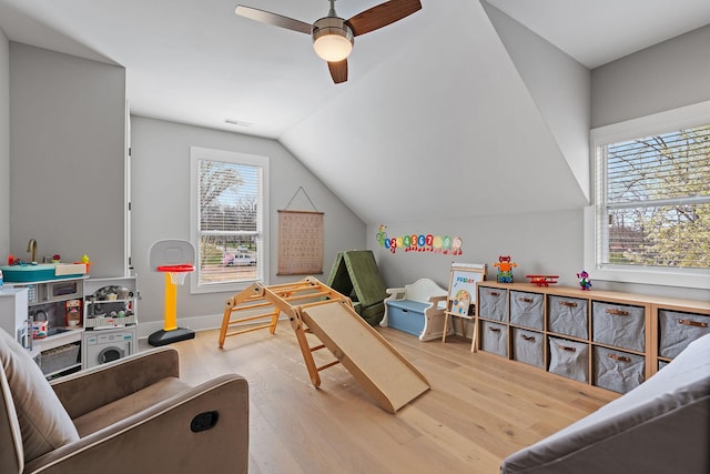 game room with visible vents, baseboards, a ceiling fan, wood finished floors, and lofted ceiling