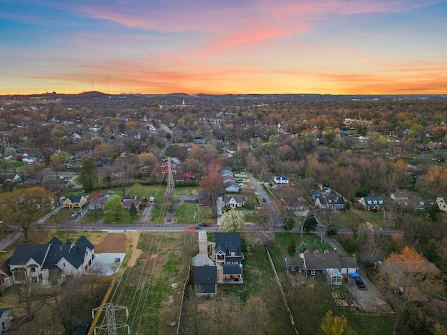 aerial view at dusk featuring a residential view