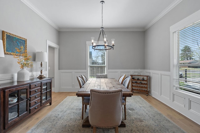 dining room featuring crown molding, plenty of natural light, and a chandelier