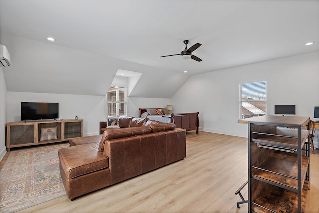 living room with a wall mounted AC, baseboards, light wood-type flooring, a ceiling fan, and lofted ceiling