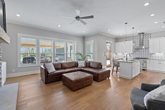 living area featuring recessed lighting, a fireplace, a ceiling fan, and ornamental molding