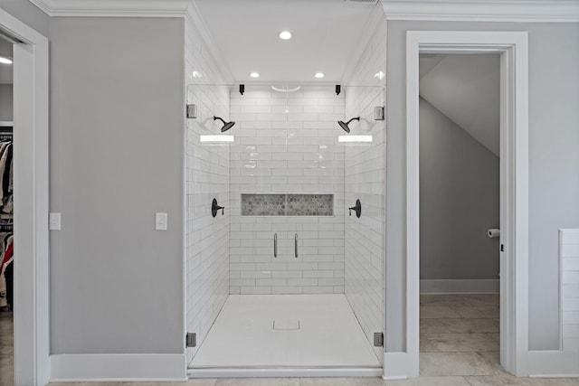 bathroom featuring baseboards, ornamental molding, a spacious closet, recessed lighting, and a stall shower