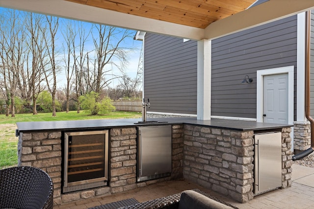 view of patio featuring exterior kitchen and beverage cooler