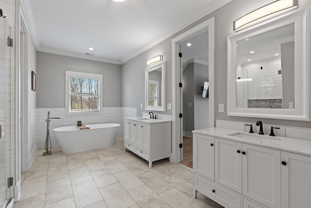 full bath with a shower stall, recessed lighting, tile walls, and a sink