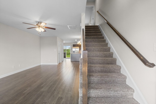 stairway with visible vents, baseboards, a ceiling fan, and wood finished floors