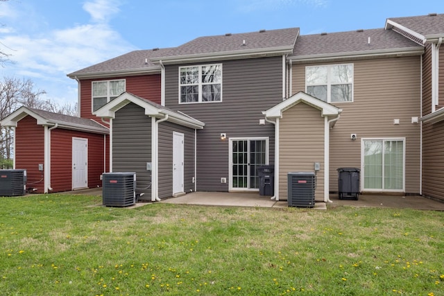 back of property with a patio area, central AC, and a lawn