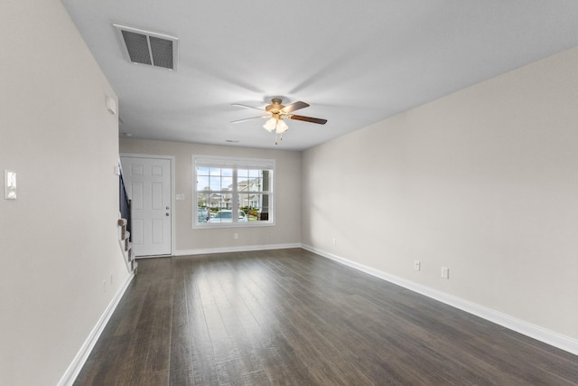 unfurnished room with ceiling fan, baseboards, dark wood finished floors, and visible vents