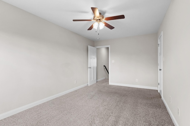 empty room with baseboards, a ceiling fan, and carpet floors