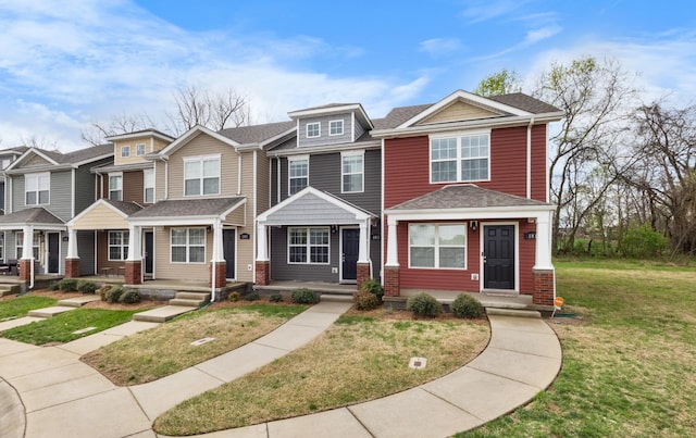 multi unit property featuring a shingled roof, a front yard, and covered porch