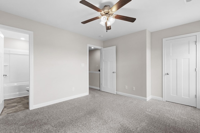unfurnished bedroom featuring carpet floors, baseboards, a ceiling fan, and connected bathroom