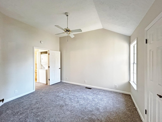 unfurnished bedroom with vaulted ceiling, visible vents, baseboards, carpet flooring, and ceiling fan