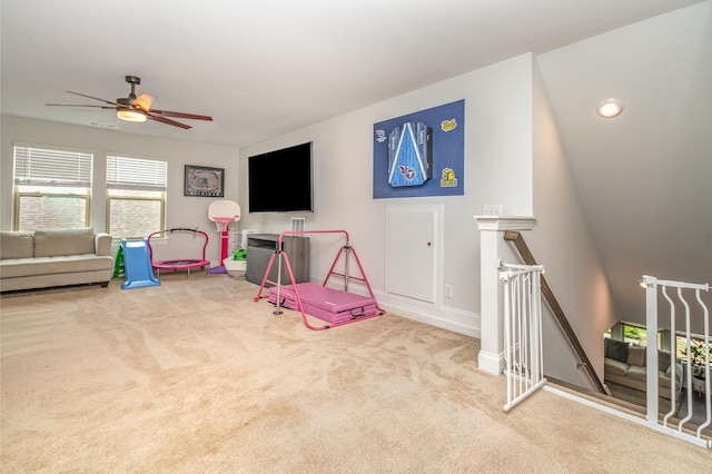 playroom featuring baseboards, a ceiling fan, and carpet