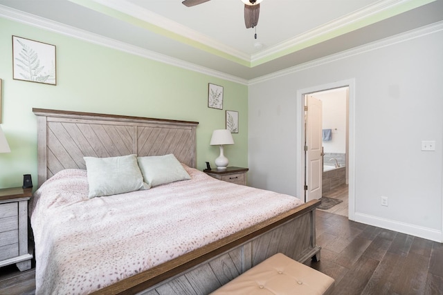 bedroom featuring baseboards, ornamental molding, ceiling fan, ensuite bath, and dark wood-type flooring