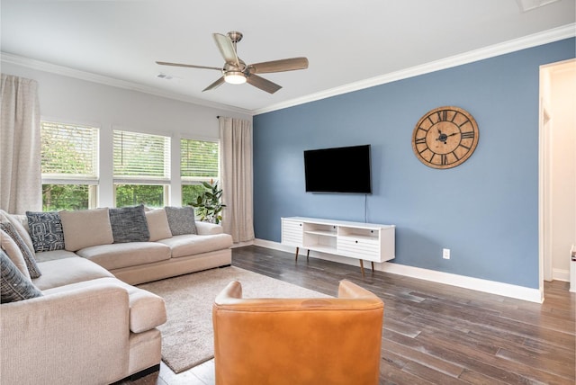 living room featuring baseboards, hardwood / wood-style floors, and ornamental molding
