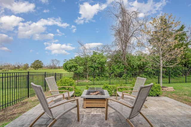 view of patio with a fenced backyard and a fire pit