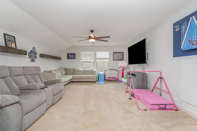 living area with ceiling fan, baseboards, vaulted ceiling, and carpet floors