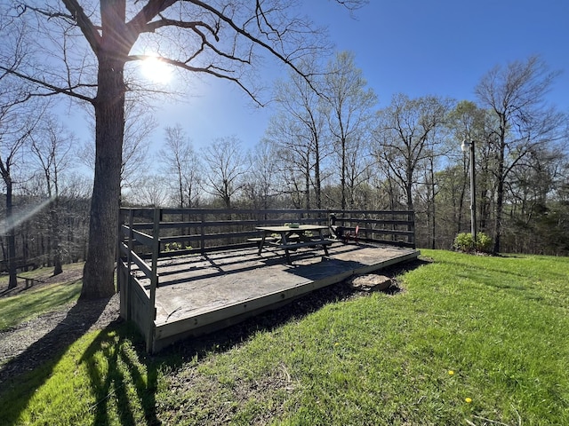 view of green lawn with a deck