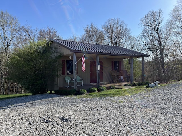 view of front facade featuring covered porch and metal roof