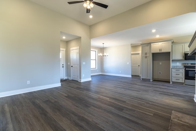 unfurnished living room with ceiling fan with notable chandelier, dark wood-style flooring, baseboards, and recessed lighting