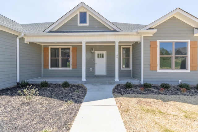 view of front of home featuring a porch and roof with shingles