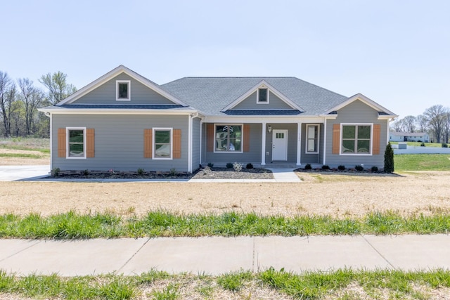 view of front of property with roof with shingles and covered porch