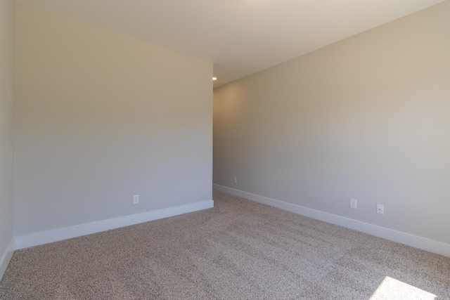 carpeted empty room with recessed lighting and baseboards