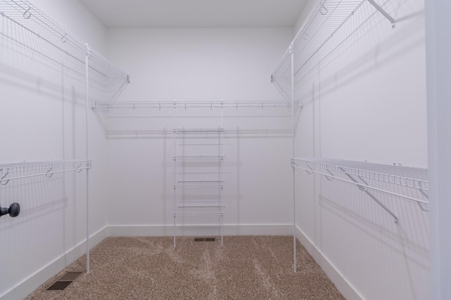 walk in closet featuring carpet and visible vents