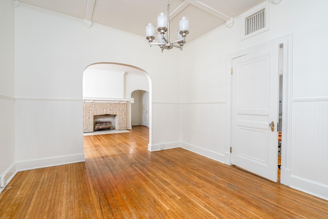 906 Myers Ave, Columbia, TN 38401 - unfurnished dining area featuring a wainscoted wall, arched walkways, visible vents, a notable chandelier, and wood finished floors