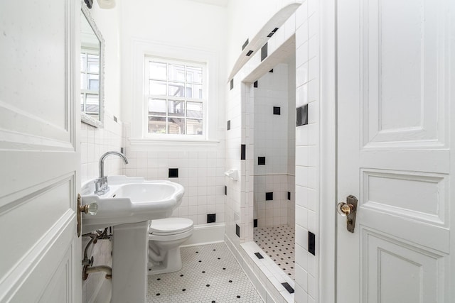 906 Myers Ave, Columbia, TN 38401 - full bathroom featuring tile walls, toilet, a stall shower, and a wainscoted wall