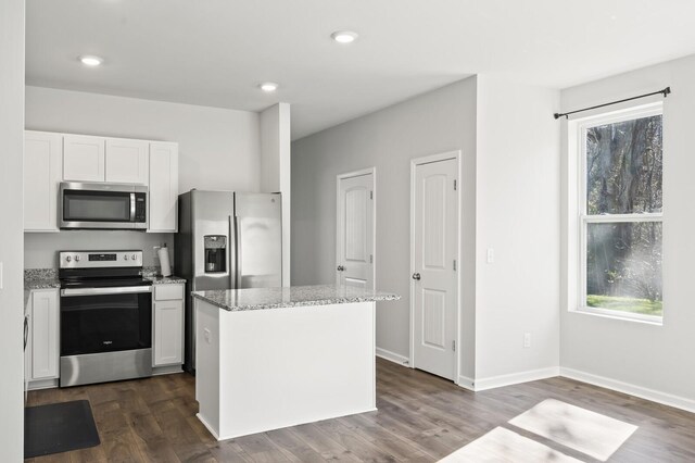 810 Dallas Dr, Columbia, TN 38401 - kitchen with a healthy amount of sunlight, a kitchen island, light stone countertops, and stainless steel appliances