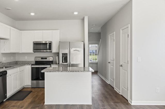 810 Dallas Dr, Columbia, TN 38401 - kitchen featuring dark wood-type flooring, appliances with stainless steel finishes, a sink, and light stone countertops