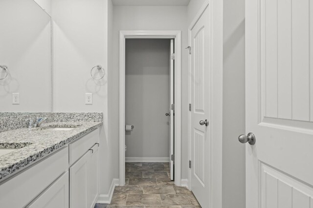 810 Dallas Dr, Columbia, TN 38401 - bathroom with stone finish floor, vanity, and baseboards