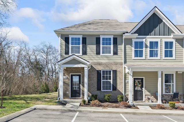 810 Dallas Dr, Columbia, TN 38401 - view of front of house featuring board and batten siding, a porch, a shingled roof, and brick siding