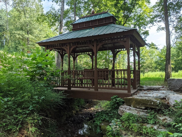 view of property's community with a gazebo and a forest view