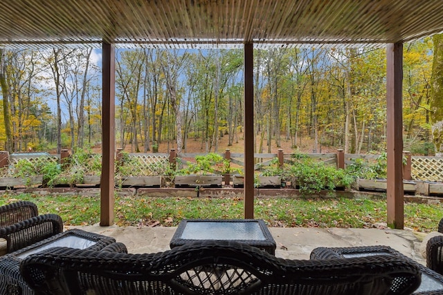 view of patio / terrace with a vegetable garden and fence