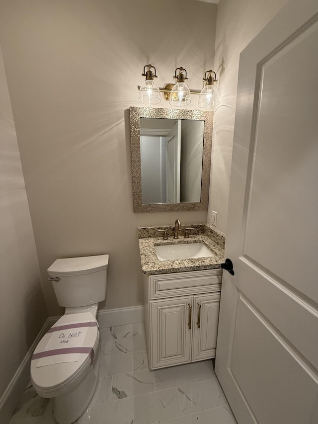 1168 N Franklin Ave, Cookeville, TN 38501 - bathroom featuring marble look tiles, toilet, vanity, and baseboards