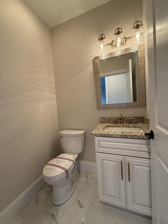 1168 N Franklin Ave, Cookeville, TN 38501 - bathroom with baseboards, toilet, marble look tile flooring, and vanity