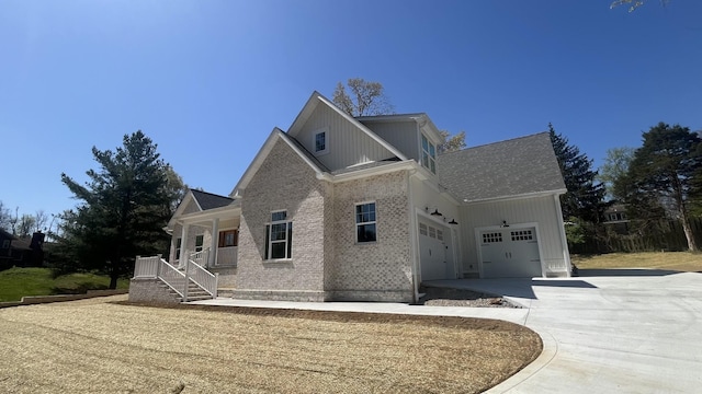 1168 N Franklin Ave, Cookeville, TN 38501 - view of front of property with covered porch, driveway, an attached garage, brick siding, and roof with shingles